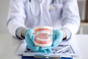 Dentist presenting dentures to a patient
