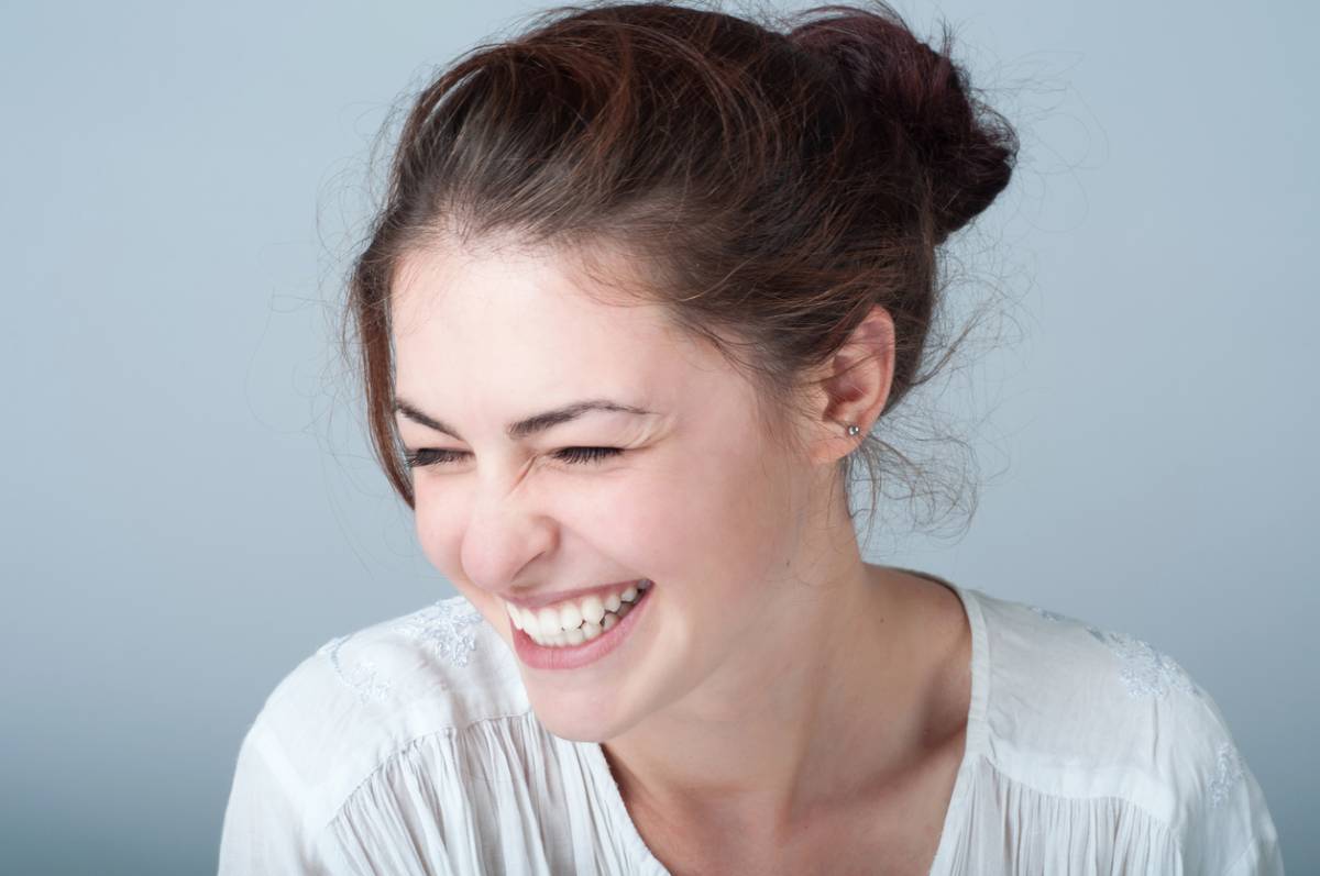 Woman who is young wondering what is the best age for getting cosmetic dental treatment.