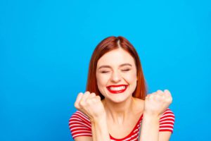 Woman smiling with cosmetic uses of dental bonding obvious in her teeth.