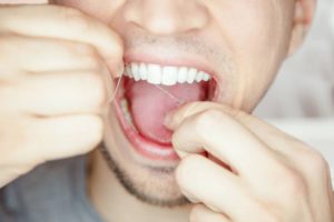 concept of dental implants and flossing
