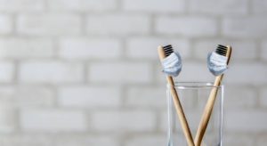 Pair of toothbrushes in a cup because you missed regular cleanings during COVID.