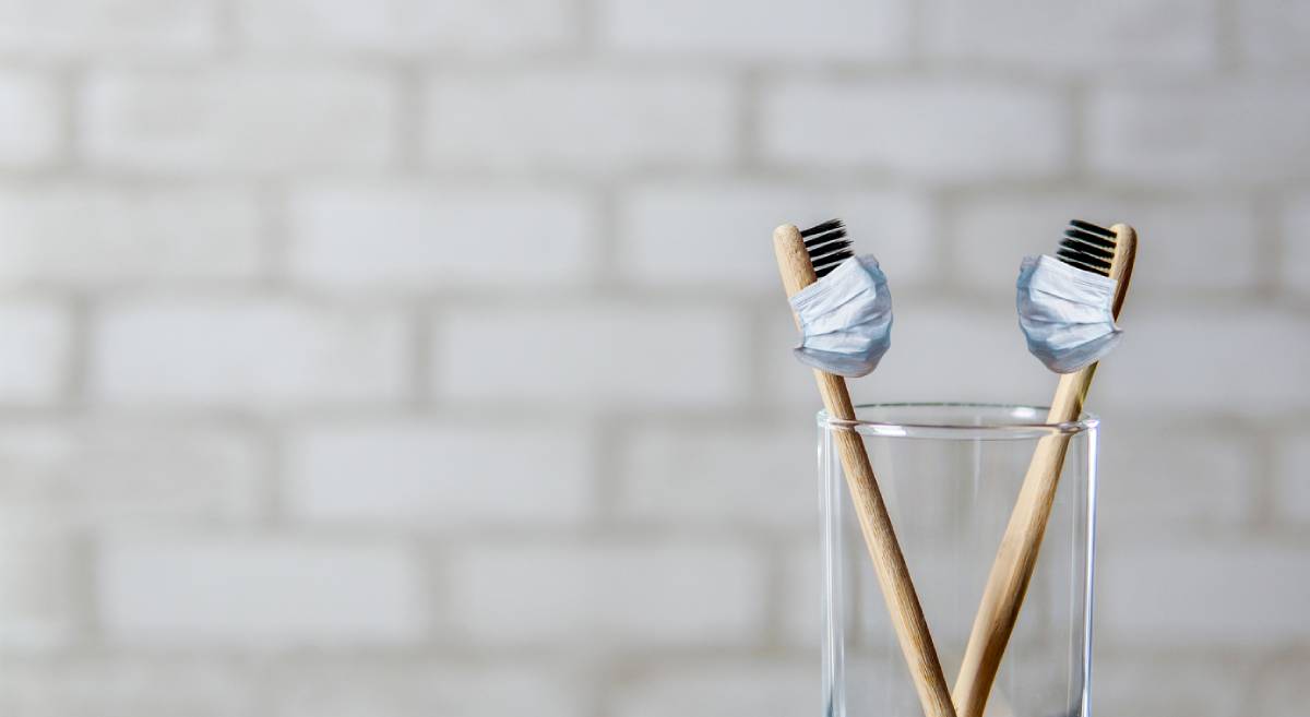 Pair of toothbrushes in a cup because you missed regular cleanings during COVID.